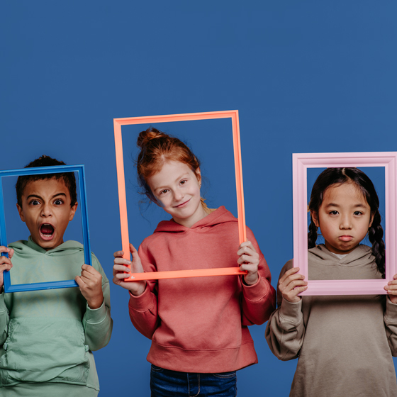 three kids showing different emotions